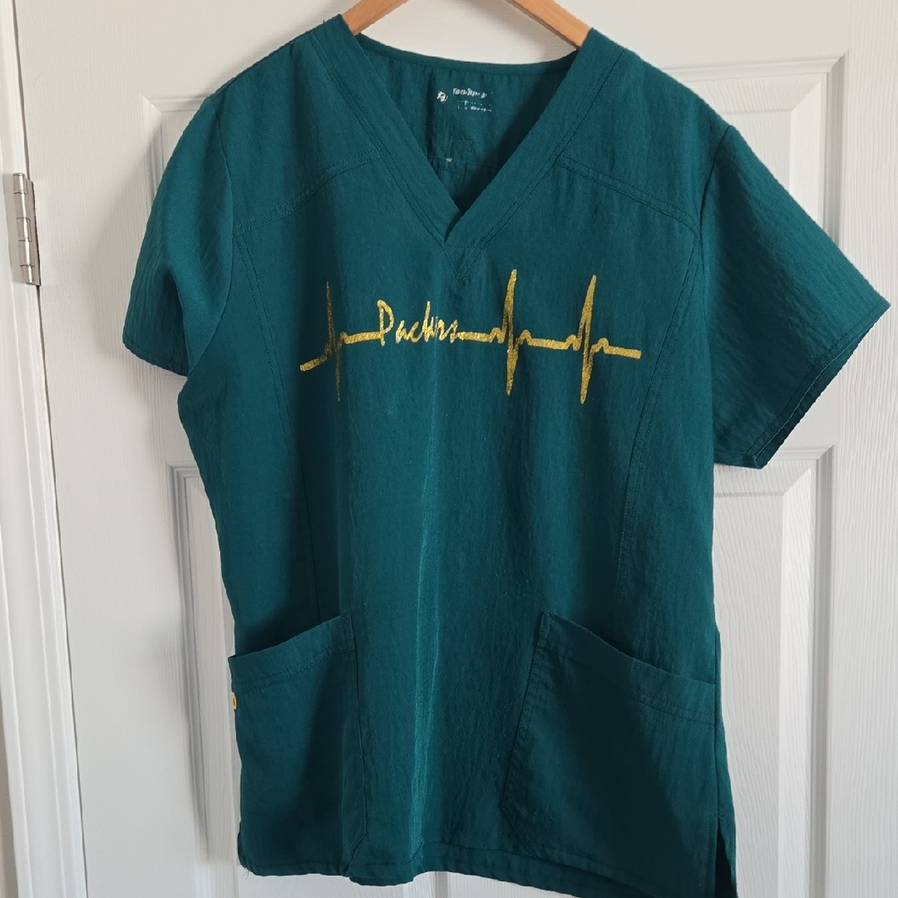 Teal Packers Wonder Wink Scrub Top with Gold Heartbeat Design